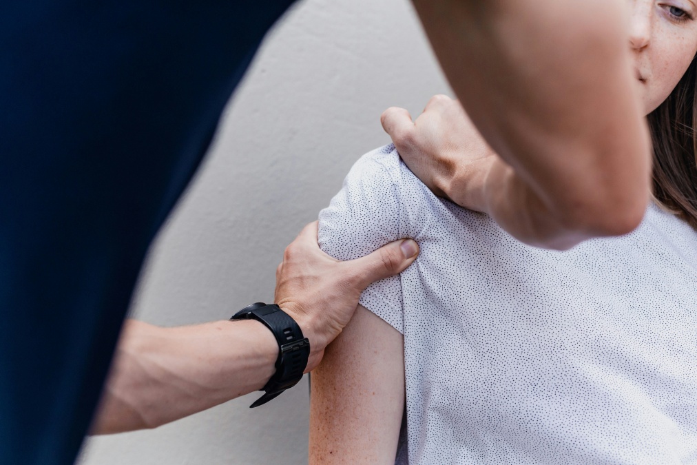 Professional physiotherapist helping patient